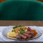 Angus steak, mashed potatoes, brazil nuts, bimi Remma's Restaurant